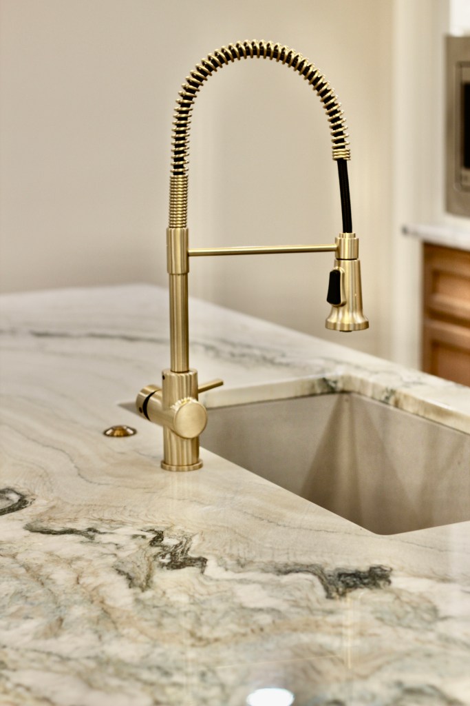 faucet in gold, quartzite countertops