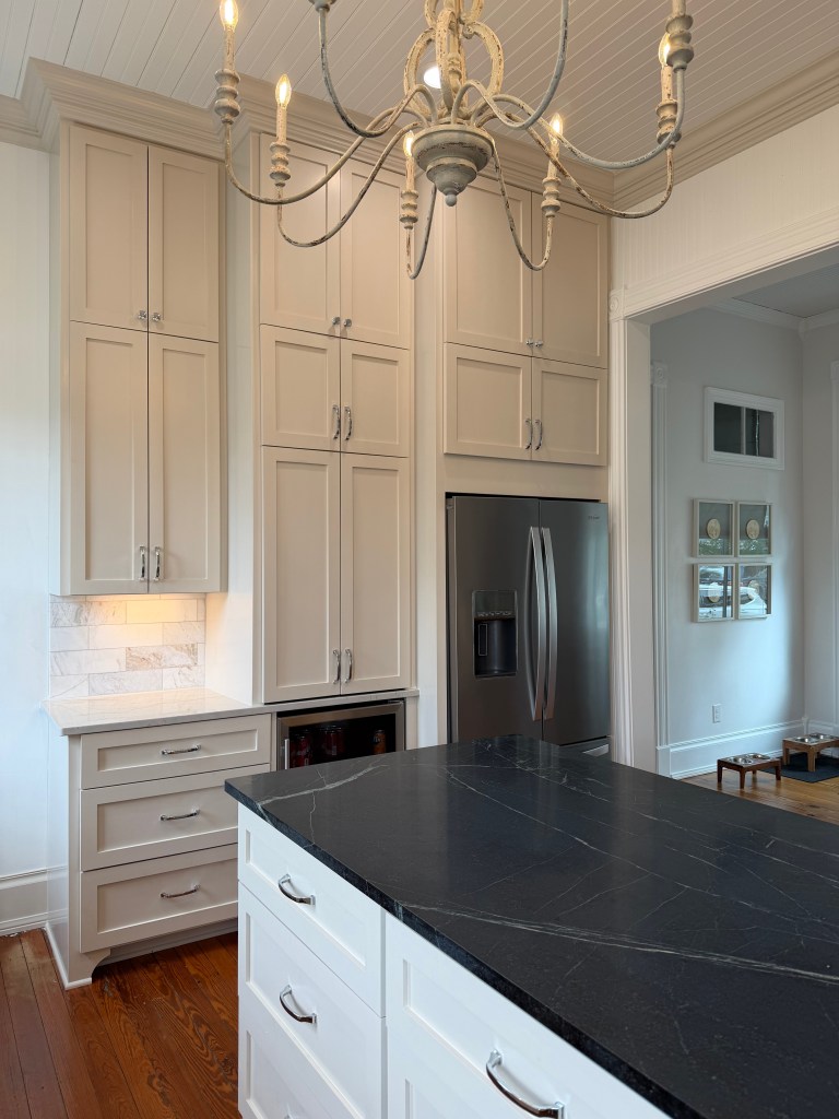 Farmhouse kitchen renovation with beige cabinets, wood floors and 12' ceilings.