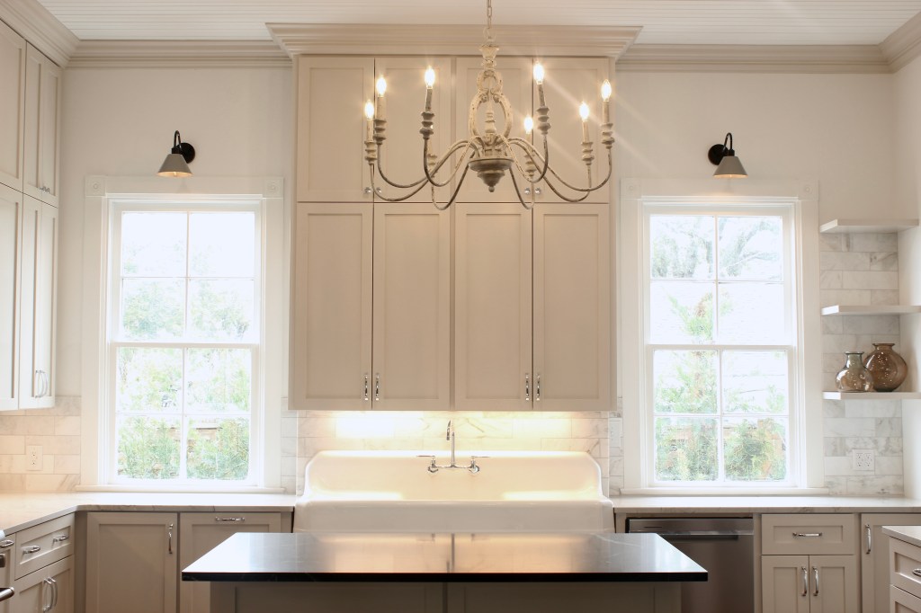 Farmhouse kitchen renovation with beige cabinets, wood floors and 12' ceilings.