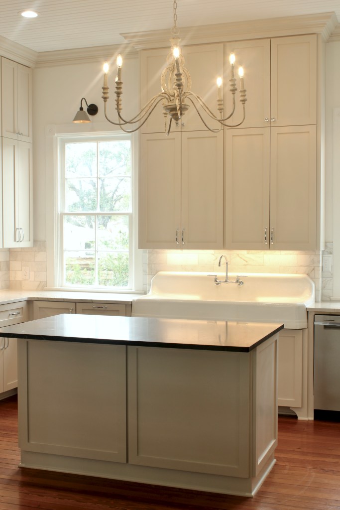 Farmhouse kitchen renovation with beige cabinets, wood floors and 12' ceilings.