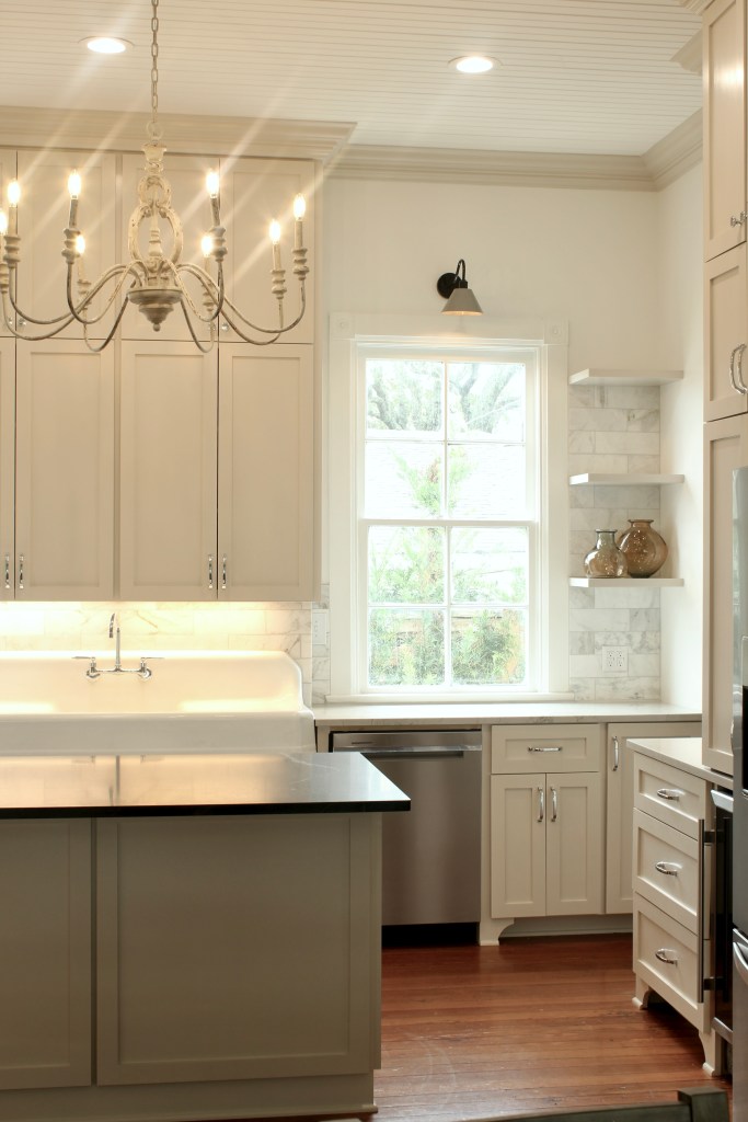 Farmhouse kitchen renovation with beige cabinets, wood floors and 12' ceilings.